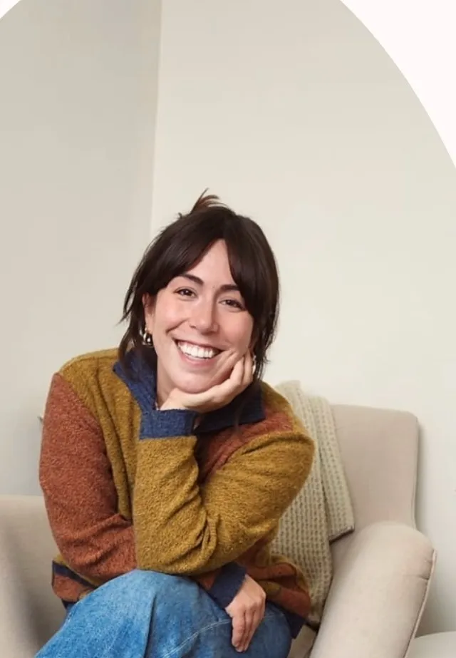 Caroleena Khayatte smiling, seated in an armchair